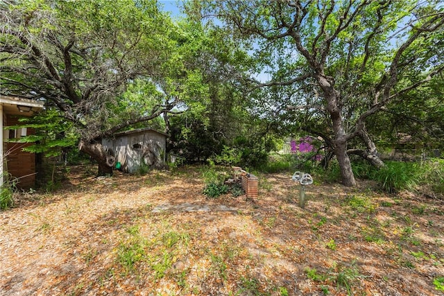 1325 S Whitney St, Aransas Pass, TX 78336 - view of yard featuring a storage unit and an outdoor structure