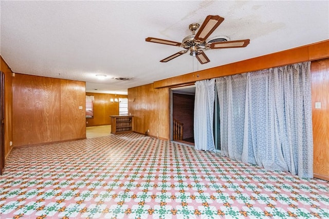 1325 S Whitney St, Aransas Pass, TX 78336 - empty room with a textured ceiling, wooden walls, and a ceiling fan