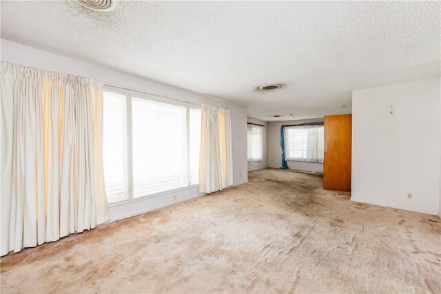 1325 S Whitney St, Aransas Pass, TX 78336 - spare room with a textured ceiling, visible vents, and carpet