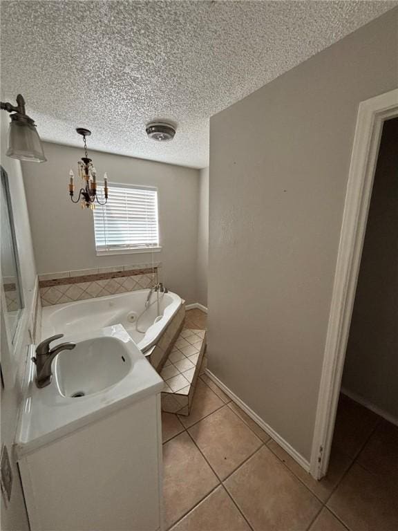 4401 River Valley Dr Unit 503, Corpus Christi, TX 78410 - full bath featuring tile patterned floors, a whirlpool tub, a textured ceiling, and a chandelier