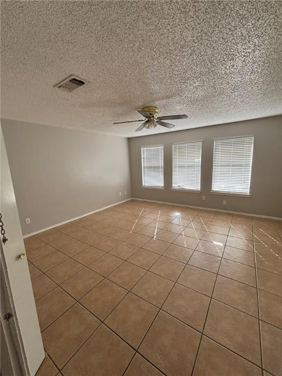 4401 River Valley Dr Unit 503, Corpus Christi, TX 78410 - spare room with tile patterned flooring, ceiling fan, and a textured ceiling