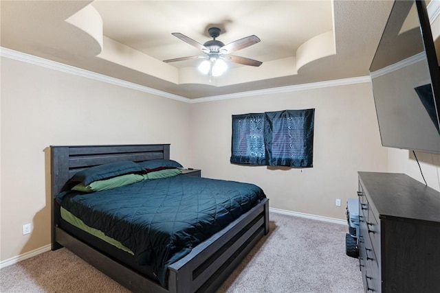 carpeted bedroom featuring a raised ceiling, ceiling fan, and crown molding