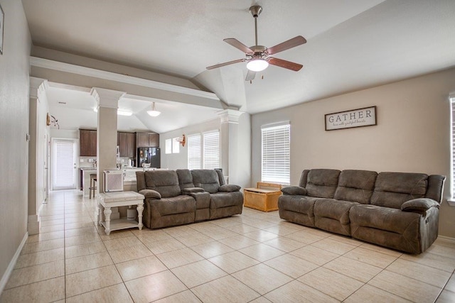 living area with lofted ceiling, ceiling fan, ornate columns, and light tile patterned floors