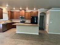 kitchen with a center island, range, and fridge