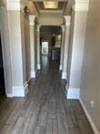 hallway with dark hardwood / wood-style flooring