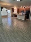 kitchen with a breakfast bar, a center island, and wood-type flooring