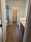 bathroom featuring vanity, wood-type flooring, and an enclosed shower