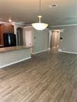 unfurnished living room featuring dark wood-type flooring