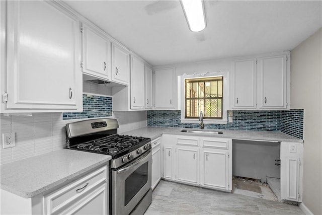 5611 Nelson, Corpus Christi, TX 78411 - kitchen with stainless steel gas range, white cabinetry, and tasteful backsplash
