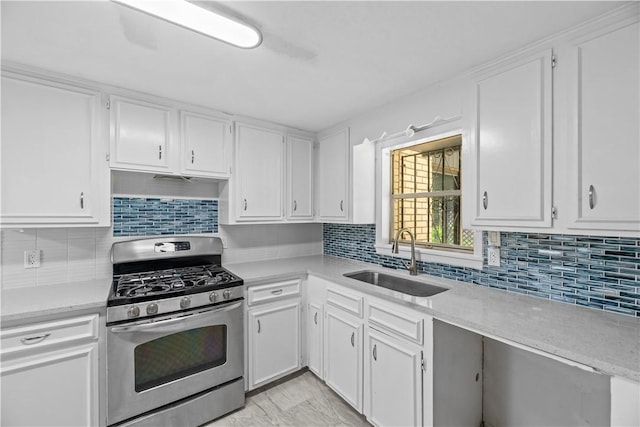 5611 Nelson, Corpus Christi, TX 78411 - kitchen with gas range, white cabinetry, and tasteful backsplash