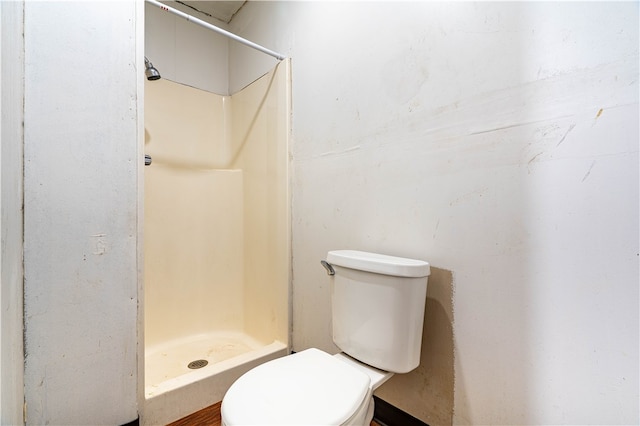 bathroom featuring a shower and toilet