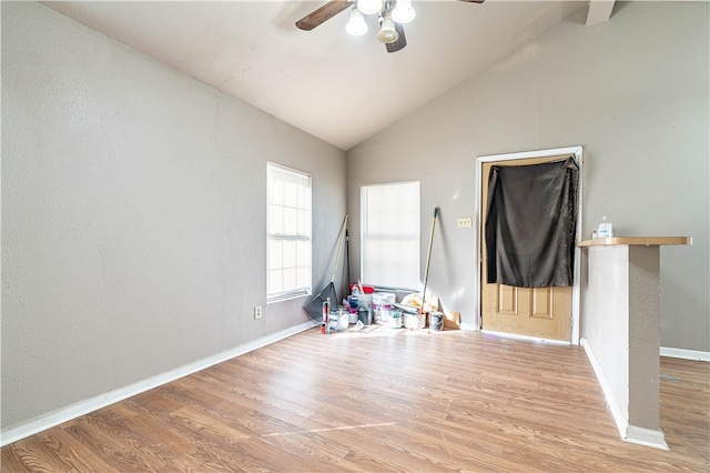 playroom featuring light wood-type flooring, ceiling fan, and high vaulted ceiling