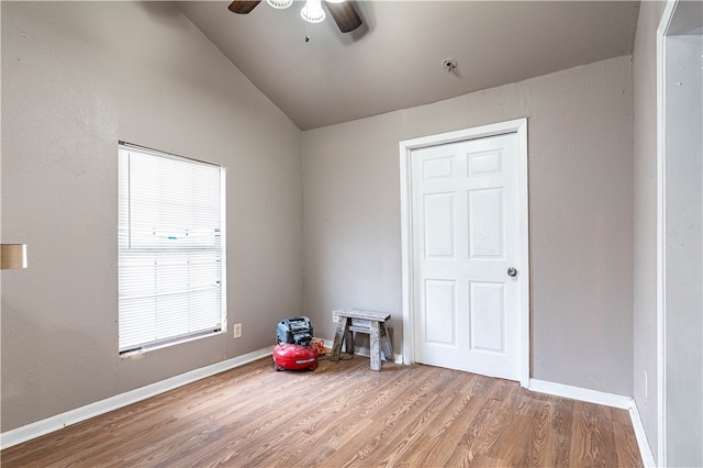 interior space with hardwood / wood-style flooring, ceiling fan, and vaulted ceiling