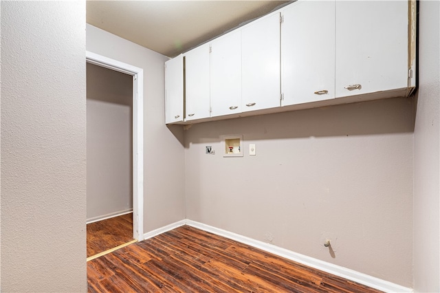 laundry area featuring cabinets, gas dryer hookup, hookup for a washing machine, and dark wood-type flooring