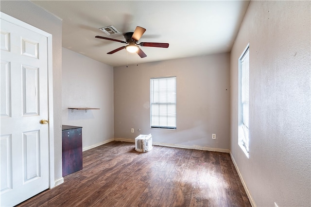 spare room featuring ceiling fan and dark hardwood / wood-style floors