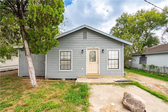 bungalow-style home with a patio