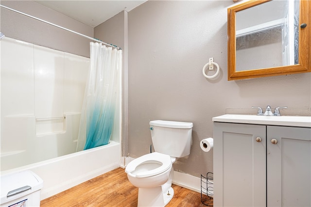 full bathroom with toilet, vanity, shower / bath combo with shower curtain, and hardwood / wood-style floors