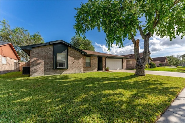 ranch-style house featuring cooling unit, a garage, and a front lawn