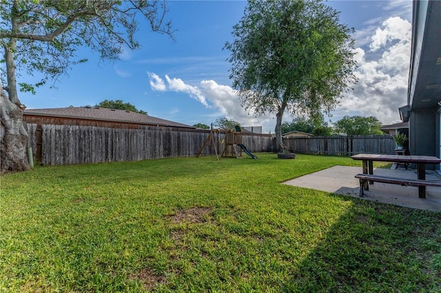 view of yard featuring a patio area and a playground