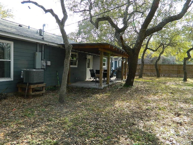 view of yard with cooling unit and a patio