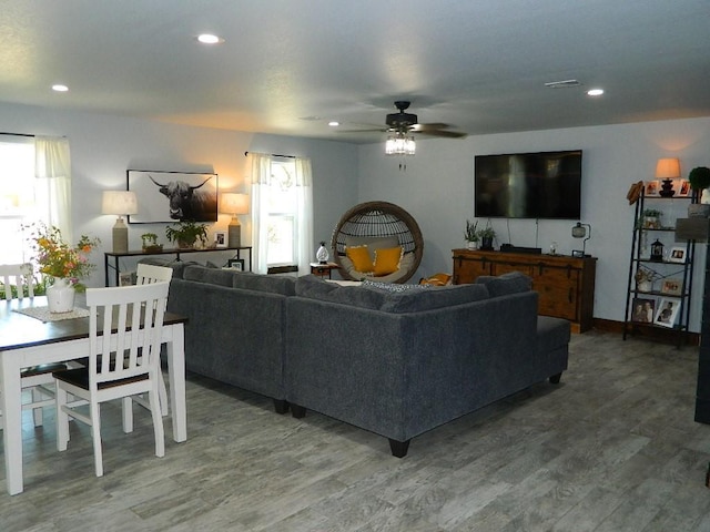 living room featuring ceiling fan and hardwood / wood-style floors