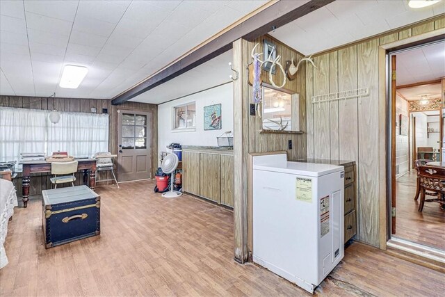 195 Carmel Dr, Sandia, TX 78383 - kitchen featuring wooden walls, wood finished floors, beam ceiling, and fridge