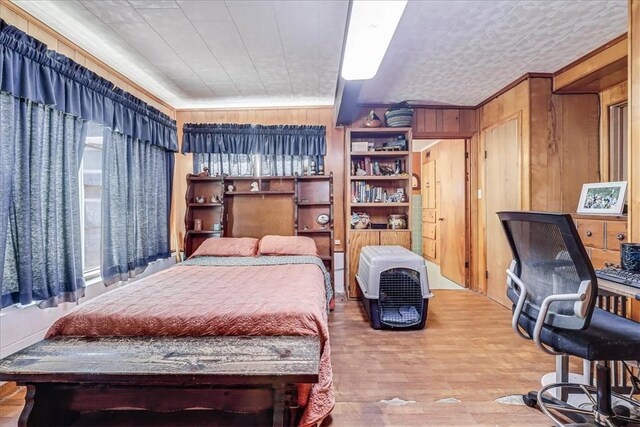 195 Carmel Dr, Sandia, TX 78383 - bedroom featuring wood finished floors and wood walls