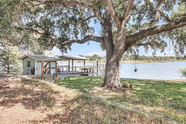 dock area featuring a water view and a yard