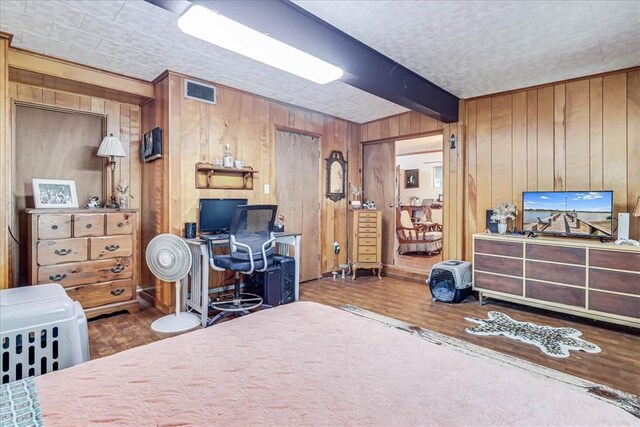 195 Carmel Dr, Sandia, TX 78383 - bedroom featuring wood finished floors, an office area, wood walls, and beam ceiling