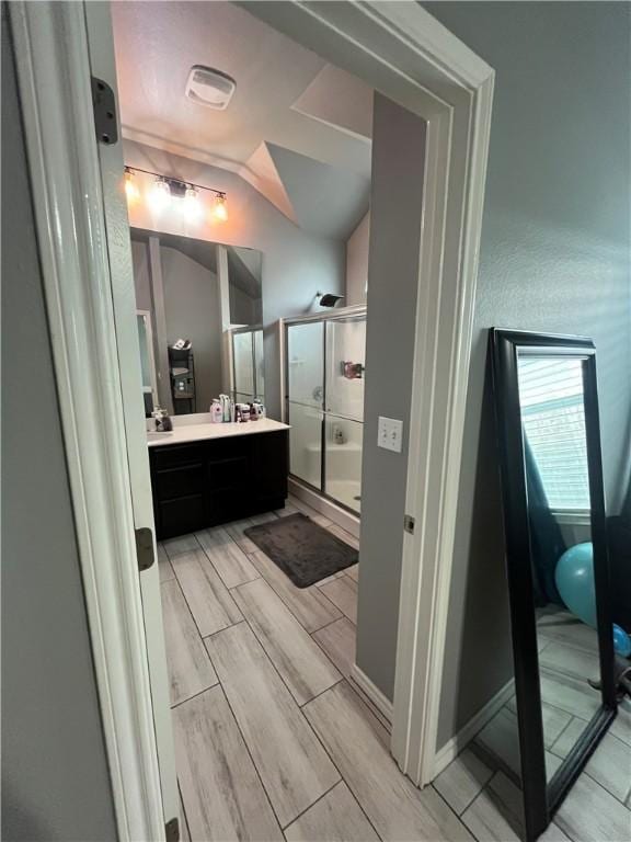 7305 Russ, Corpus Christi, TX 78414 - full bathroom featuring vanity, a shower stall, vaulted ceiling, and wood tiled floors