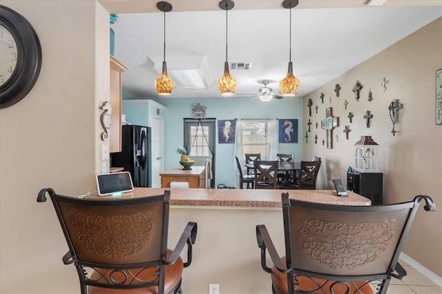 6517 Marblewing Dr, Corpus Christi, TX 78414 - kitchen featuring black refrigerator with ice dispenser, ceiling fan, pendant lighting, and tile patterned flooring