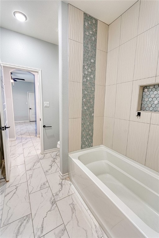 bathroom featuring a bathtub and toilet