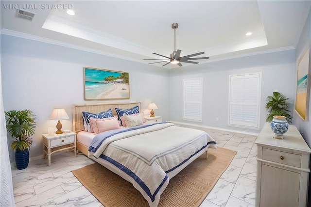 bedroom featuring ceiling fan, ornamental molding, and a tray ceiling