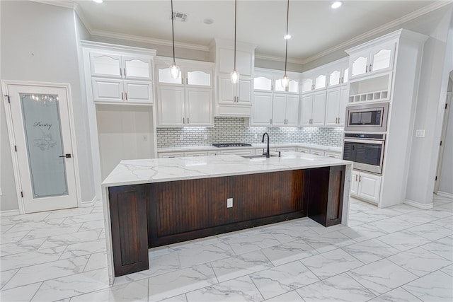 kitchen featuring white cabinets, a kitchen island with sink, and appliances with stainless steel finishes