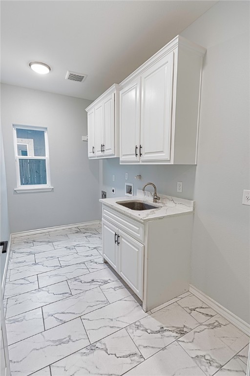 laundry area featuring sink, hookup for a washing machine, cabinets, and hookup for an electric dryer