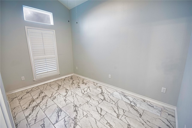 empty room featuring high vaulted ceiling