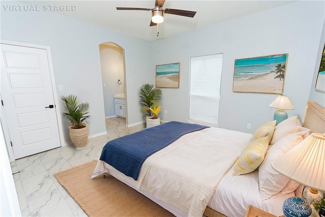 bedroom featuring connected bathroom and ceiling fan