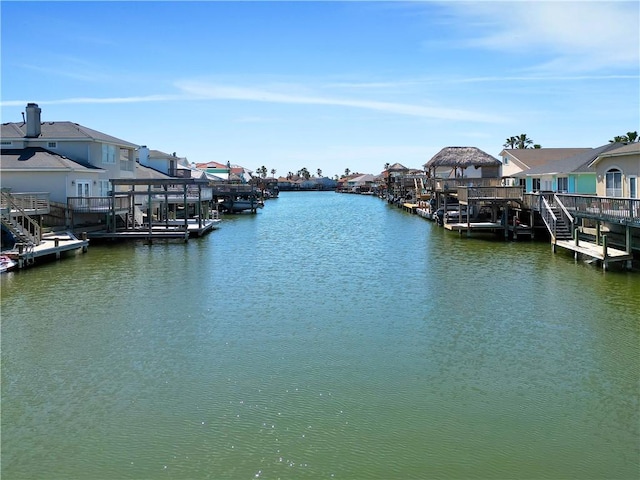 view of dock with a water view and a residential view