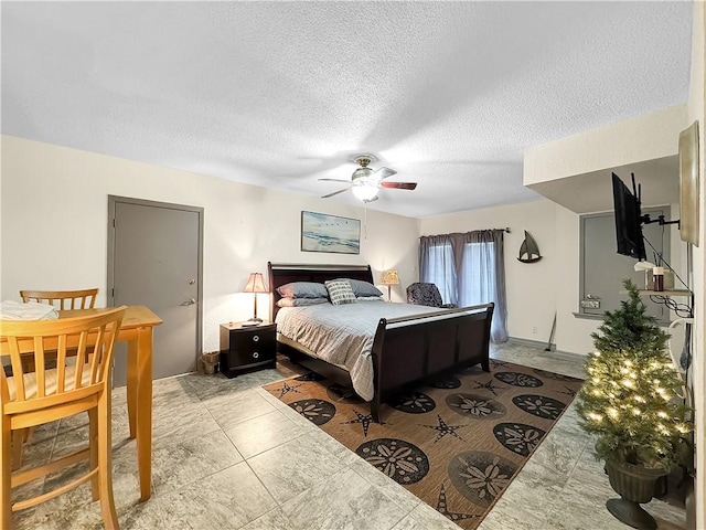 bedroom with a textured ceiling and ceiling fan