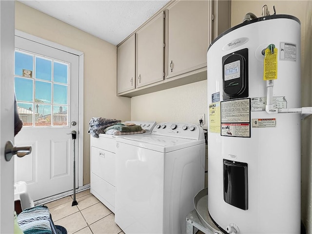 laundry room featuring light tile patterned flooring, cabinet space, washing machine and dryer, and water heater
