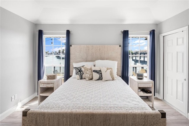 bedroom featuring light wood-type flooring and baseboards