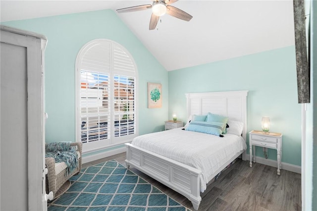 bedroom featuring dark wood-style floors, lofted ceiling, a ceiling fan, and baseboards