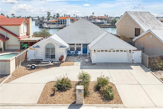 view of front of house featuring a garage, a shingled roof, fence, and concrete driveway