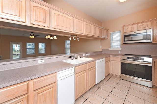 kitchen with stainless steel appliances, kitchen peninsula, sink, light tile patterned flooring, and light brown cabinets