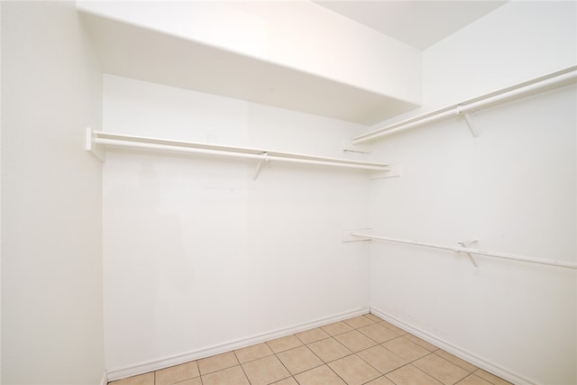 spacious closet with light tile patterned floors