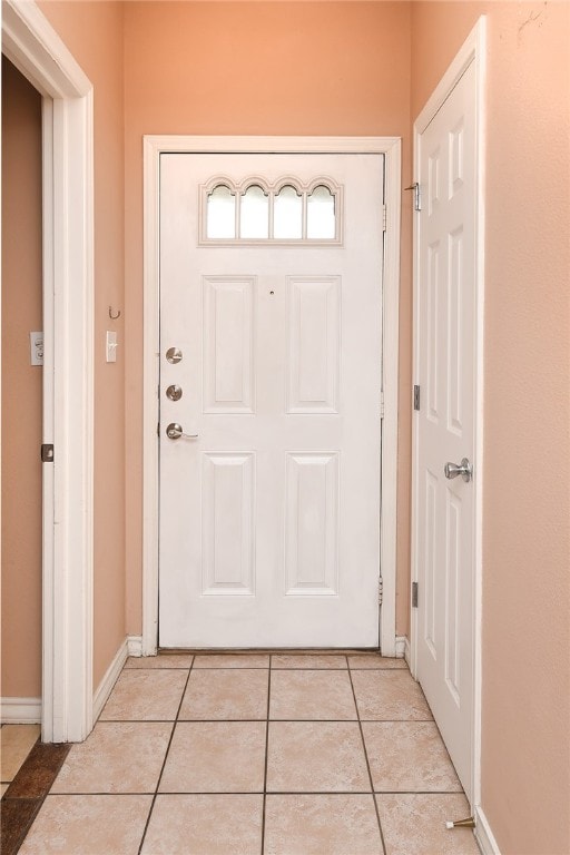 doorway to outside featuring light tile patterned floors