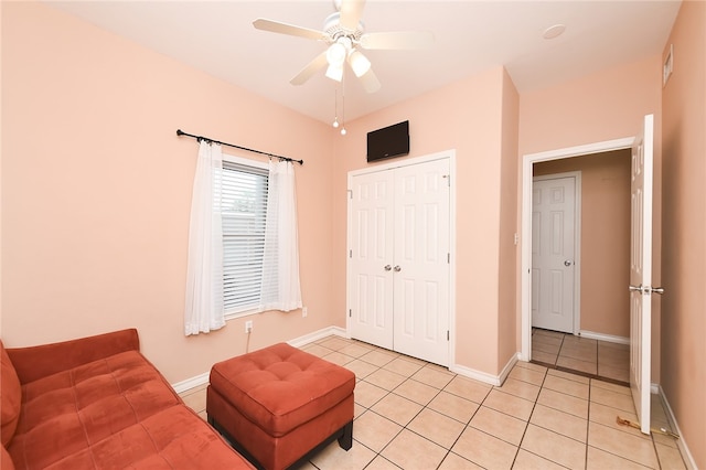 living area featuring ceiling fan and light tile patterned floors