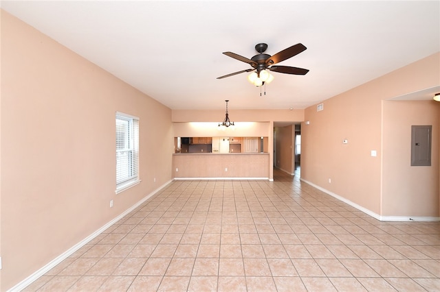 unfurnished living room featuring electric panel, ceiling fan with notable chandelier, and light tile patterned floors