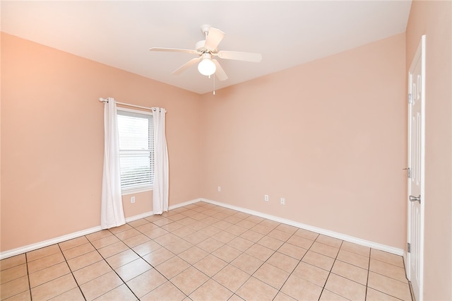 tiled spare room featuring ceiling fan