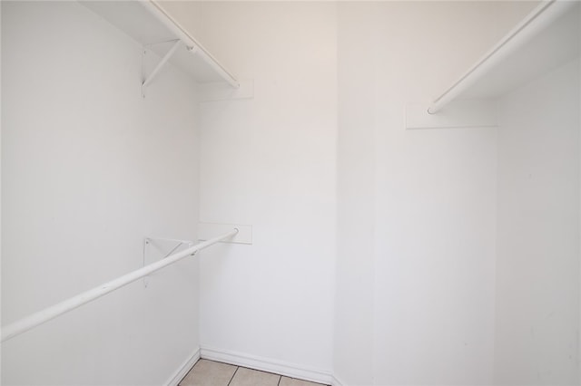 spacious closet with light tile patterned floors